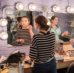 Theatre student putting on makeup for the University of Findlay's musical performance.