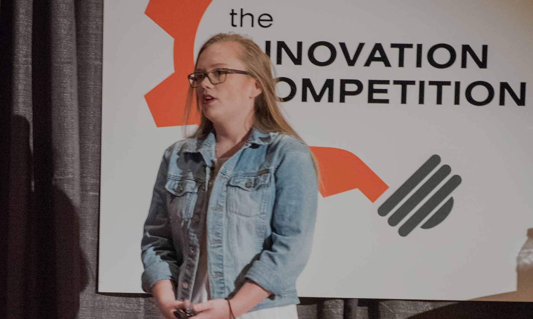 Business student presenting business idea at innovation competition.